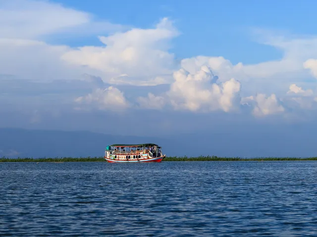 A boat crossing a haor wetland in Sunamganj